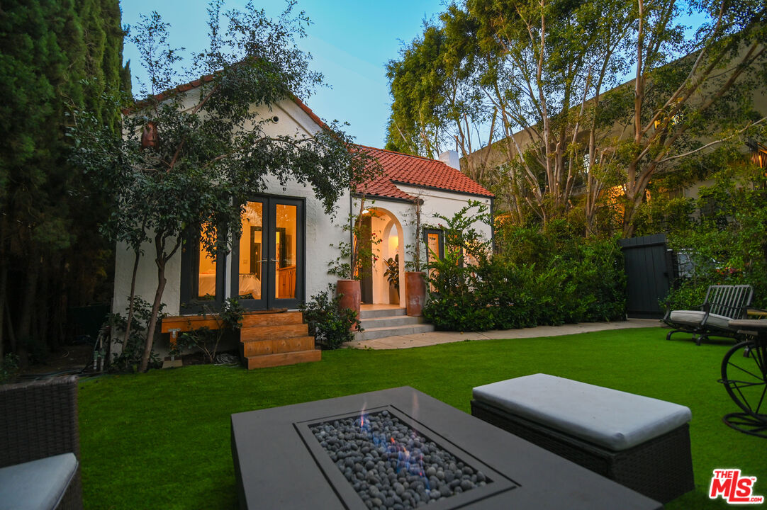 a view of yard with swimming pool and green space