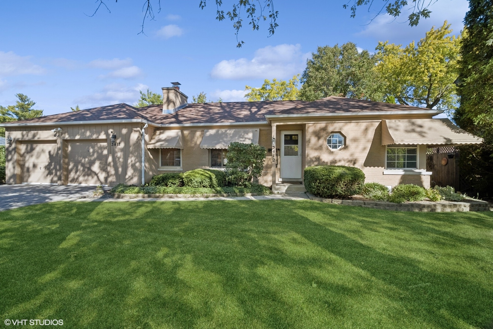 a view of a house with backyard sitting area and garden