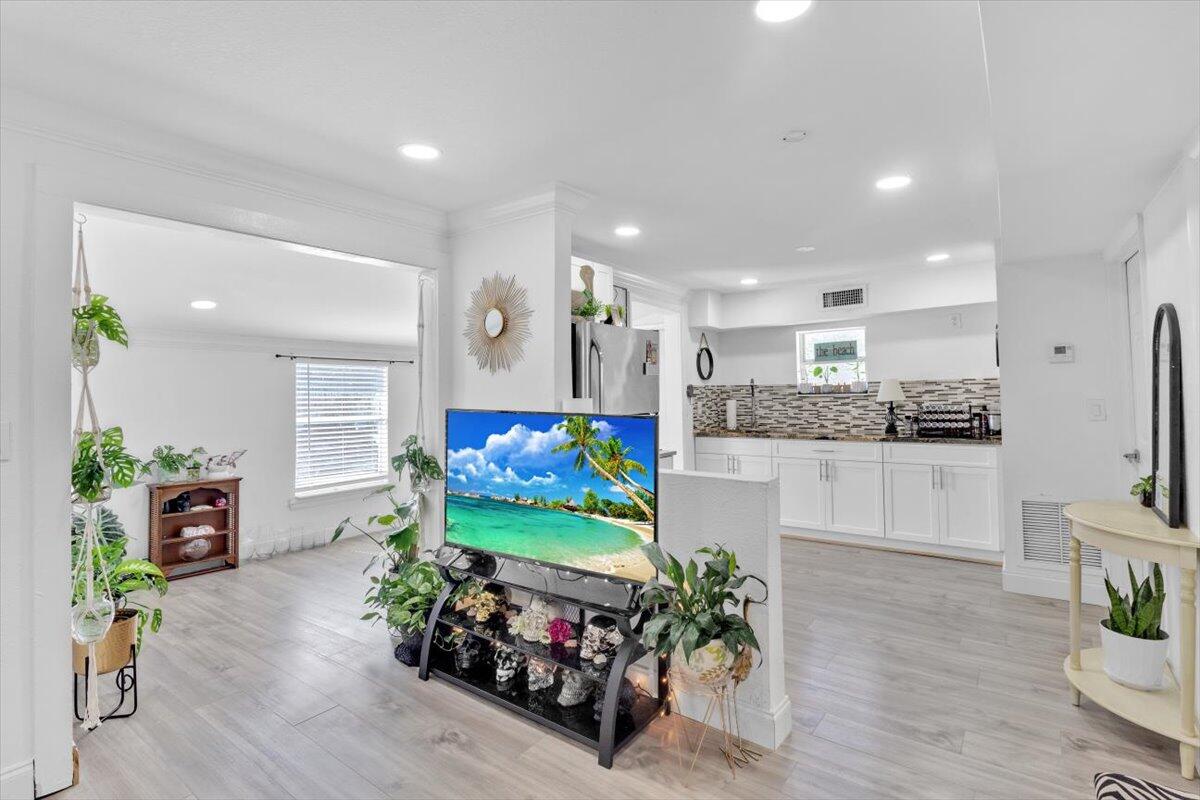 a kitchen with stainless steel appliances kitchen island granite countertop a refrigerator and a sink