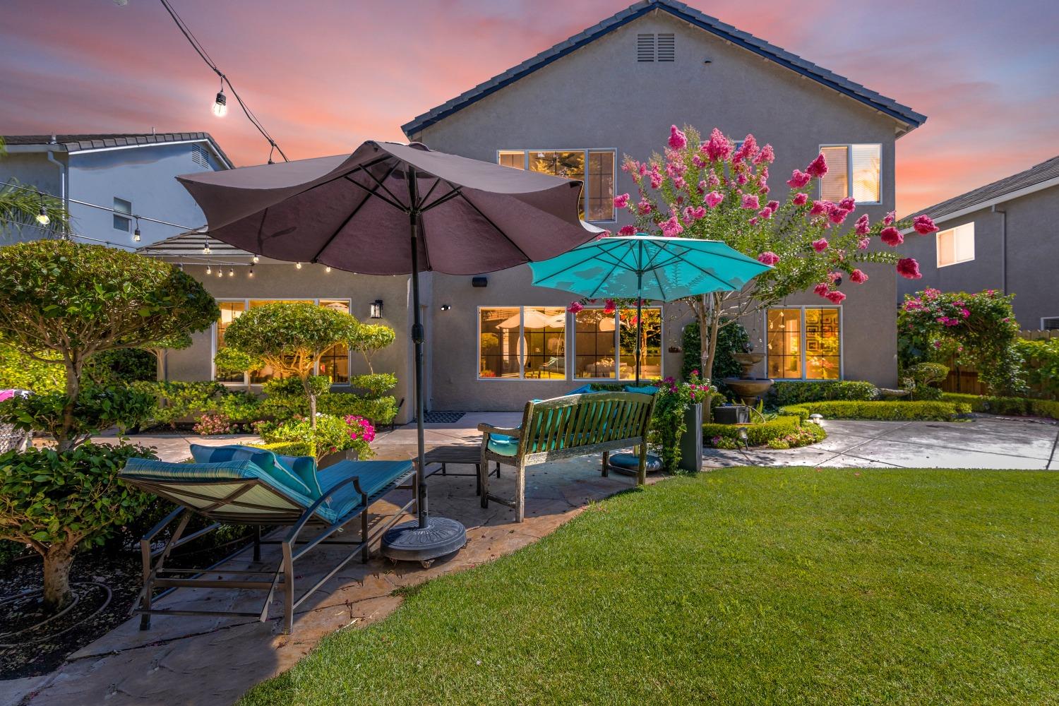 a view of a house with backyard sitting area and garden