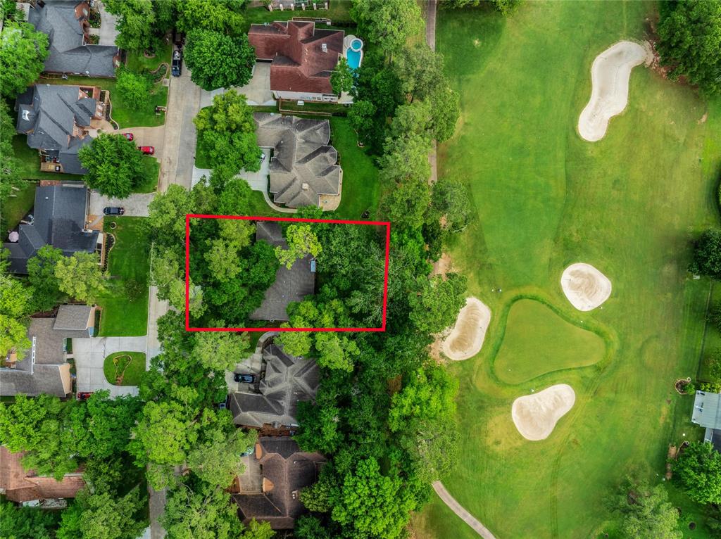 an aerial view of a residential house with an outdoor space and street view