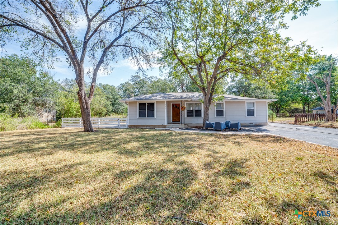 a front view of house with yard and trees