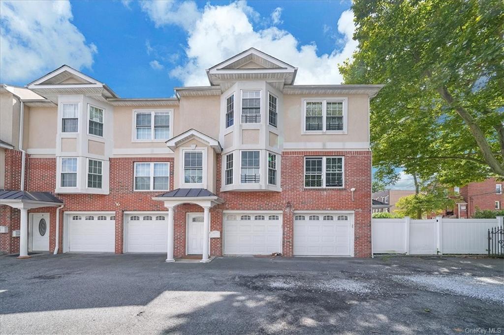 Townhome / multi-family property featuring a garage