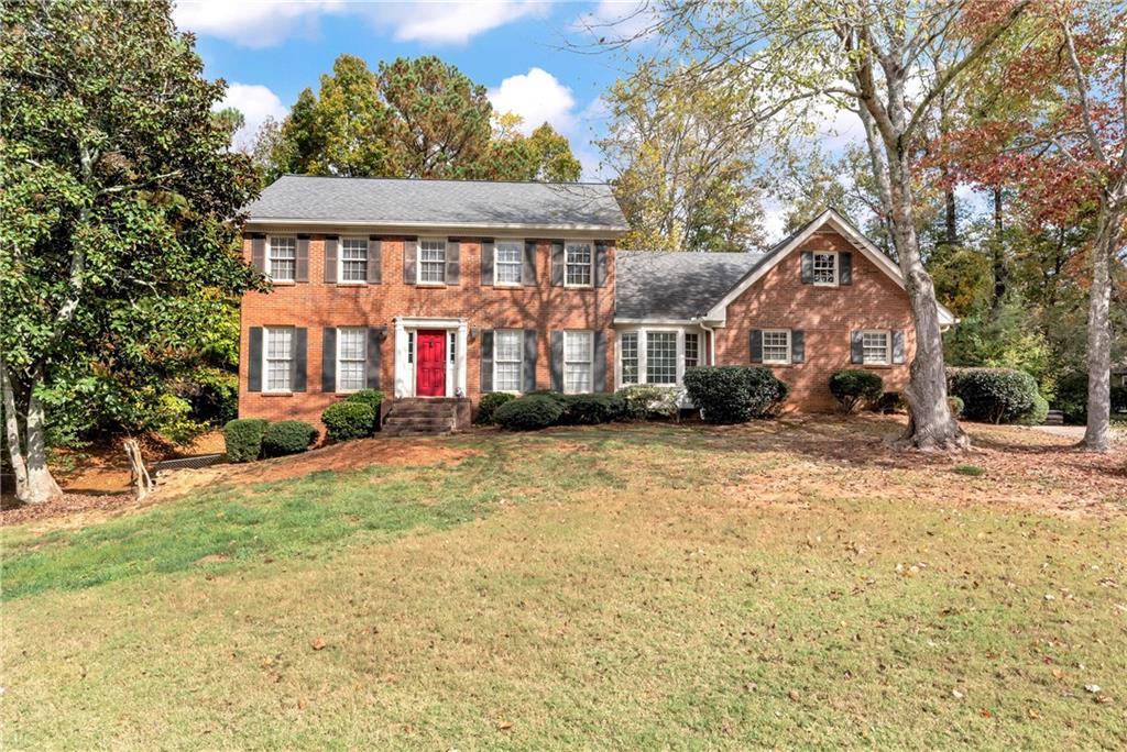 a front view of a house with a yard