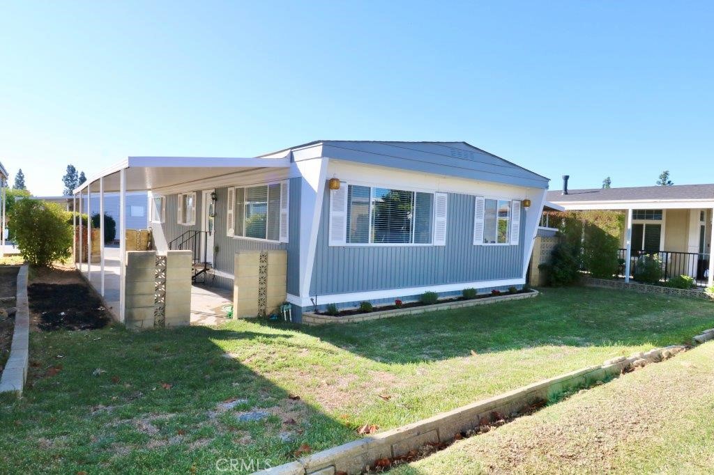 a view of house with backyard