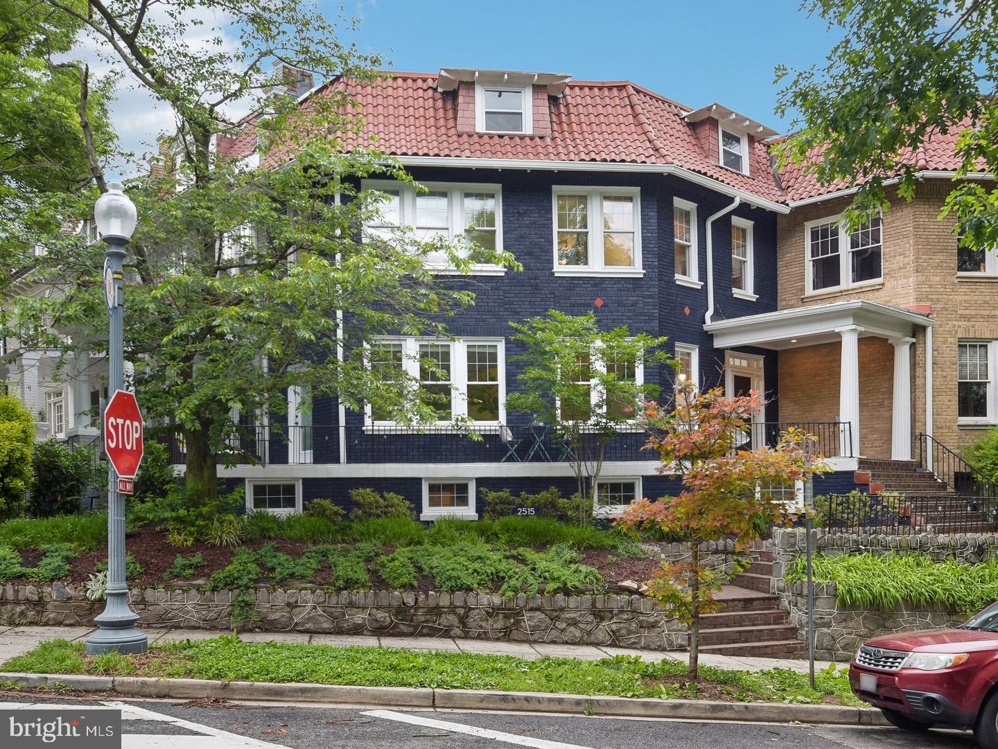 a front view of a house with a yard and plants