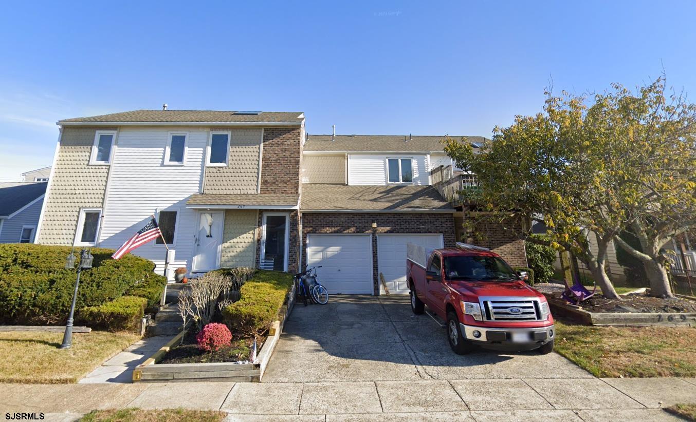 a front view of a house with parking