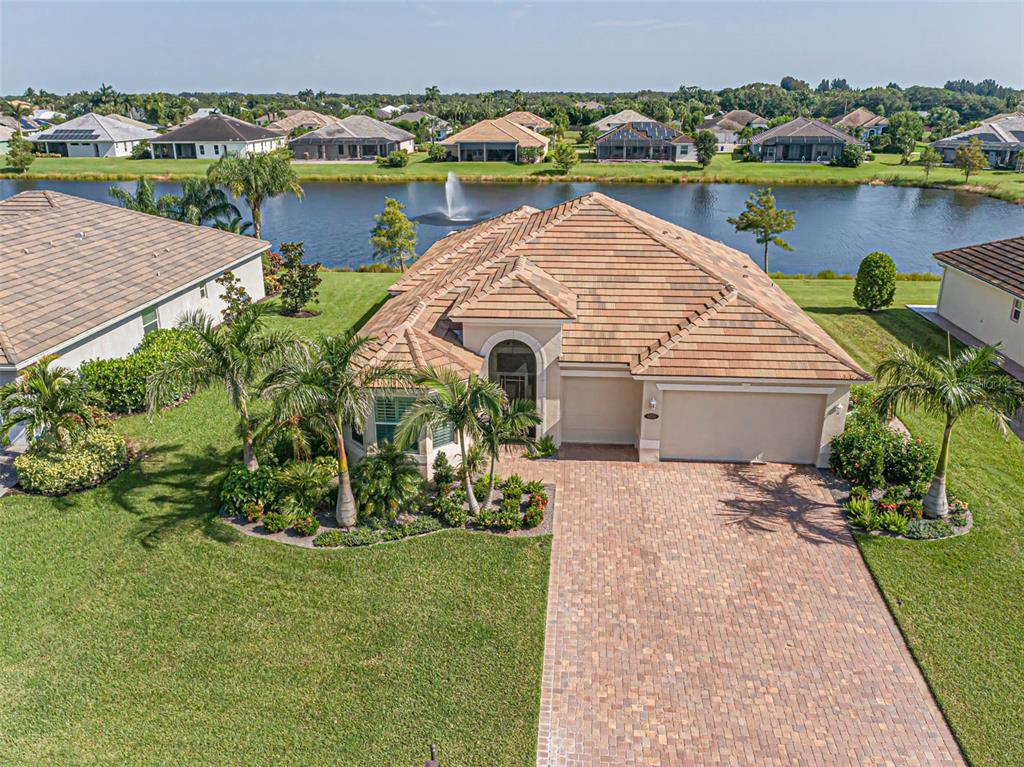 an aerial view of a house with a lake view