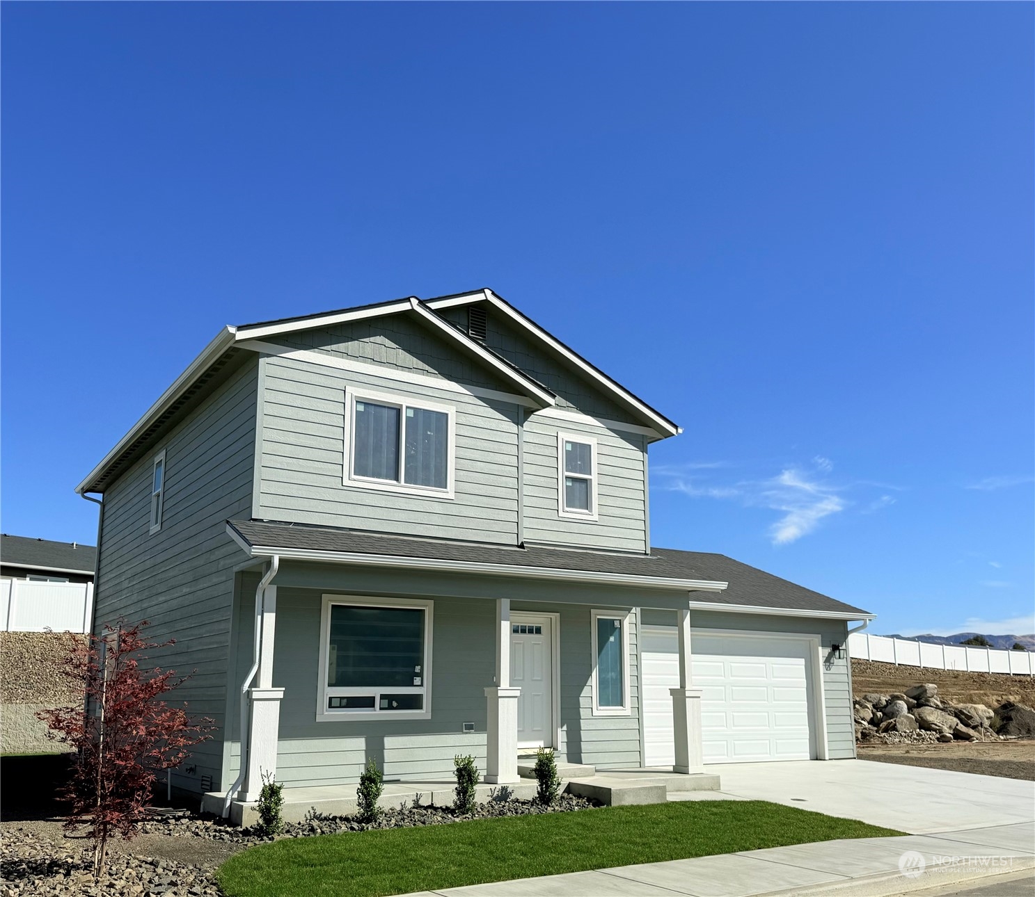 a front view of a house with a garden and yard