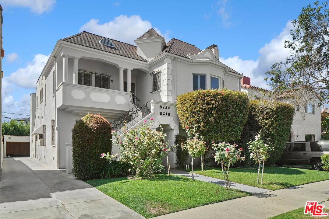 a front view of a house with a garden