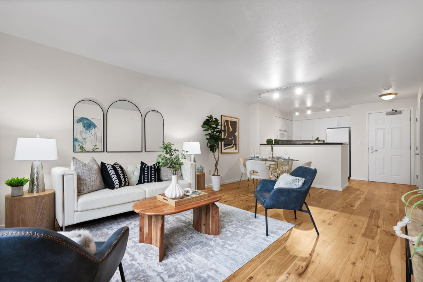 a living room with furniture and kitchen view