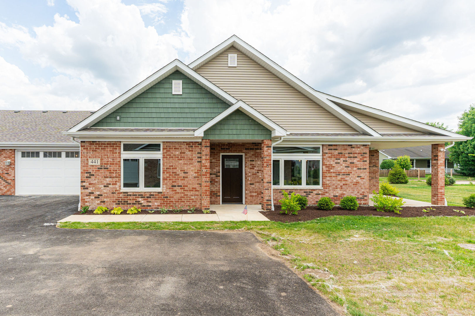 a front view of house with yard outdoor seating and garage