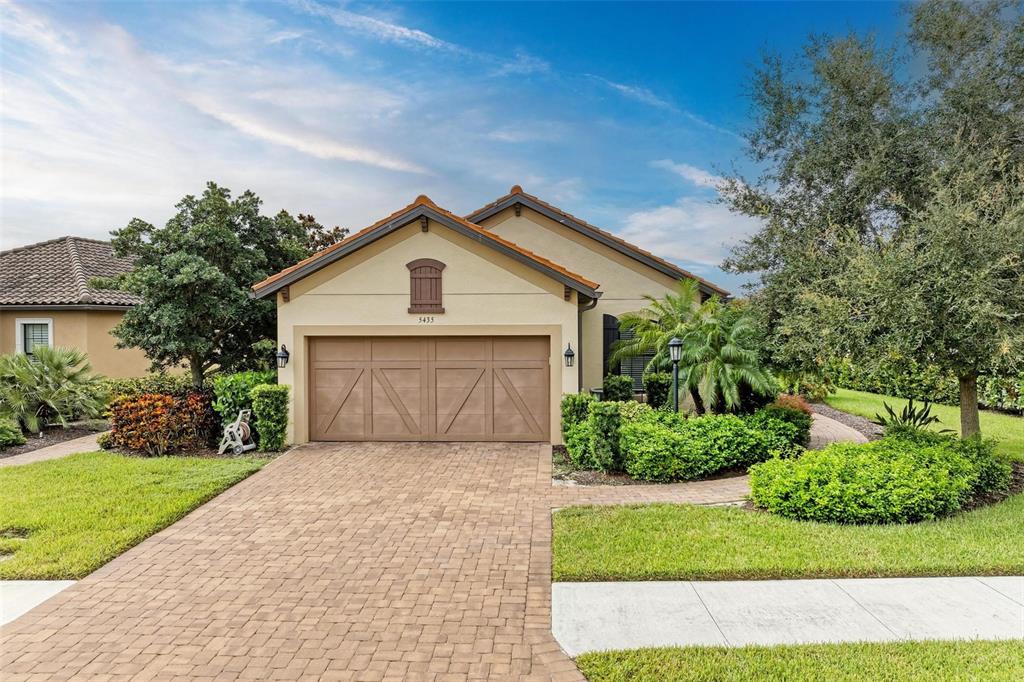 a front view of a house with a yard and garage