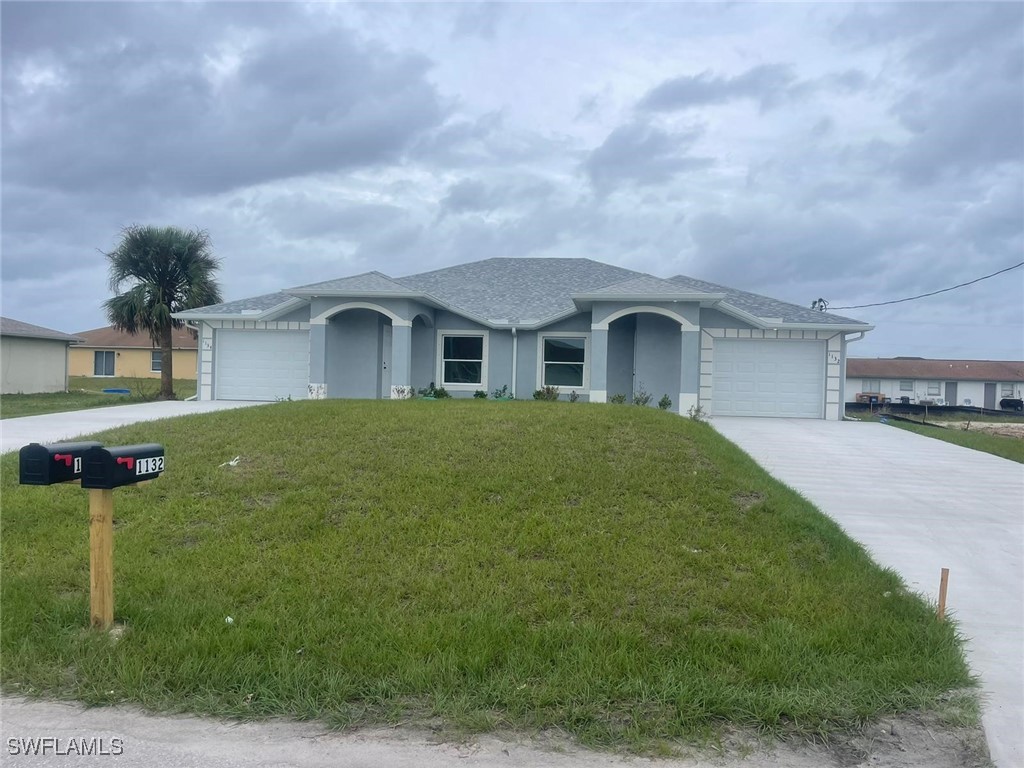 a front view of a house with garden