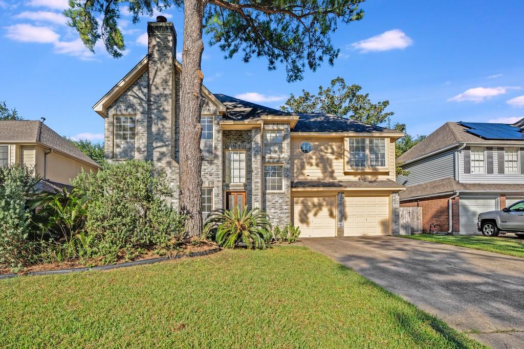 a front view of a house with a yard and fountain