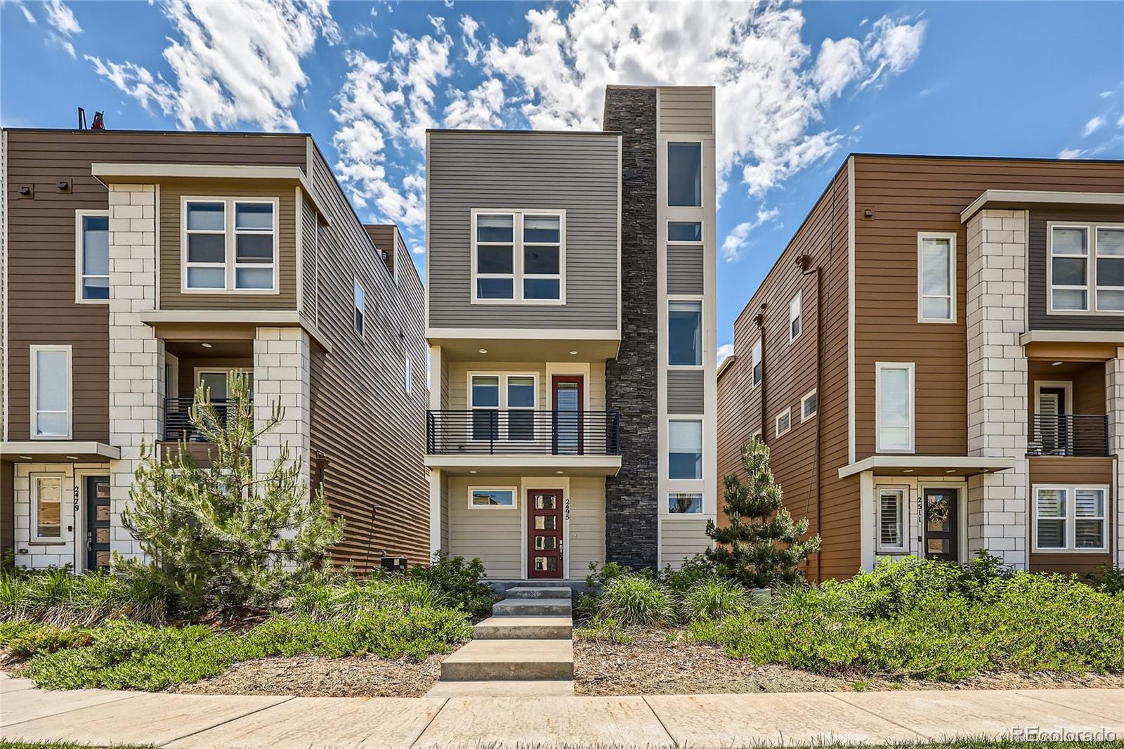 a front view of a residential houses with yard