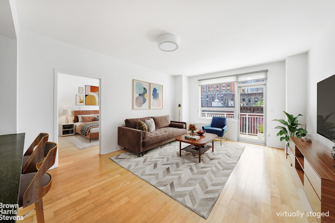 a living room with furniture large window and a table