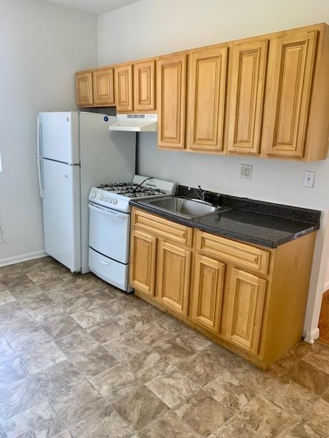 a kitchen with a refrigerator stove and cabinets