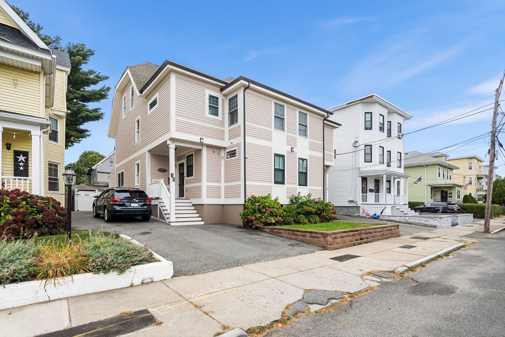 a front view of a residential apartment building with a yard