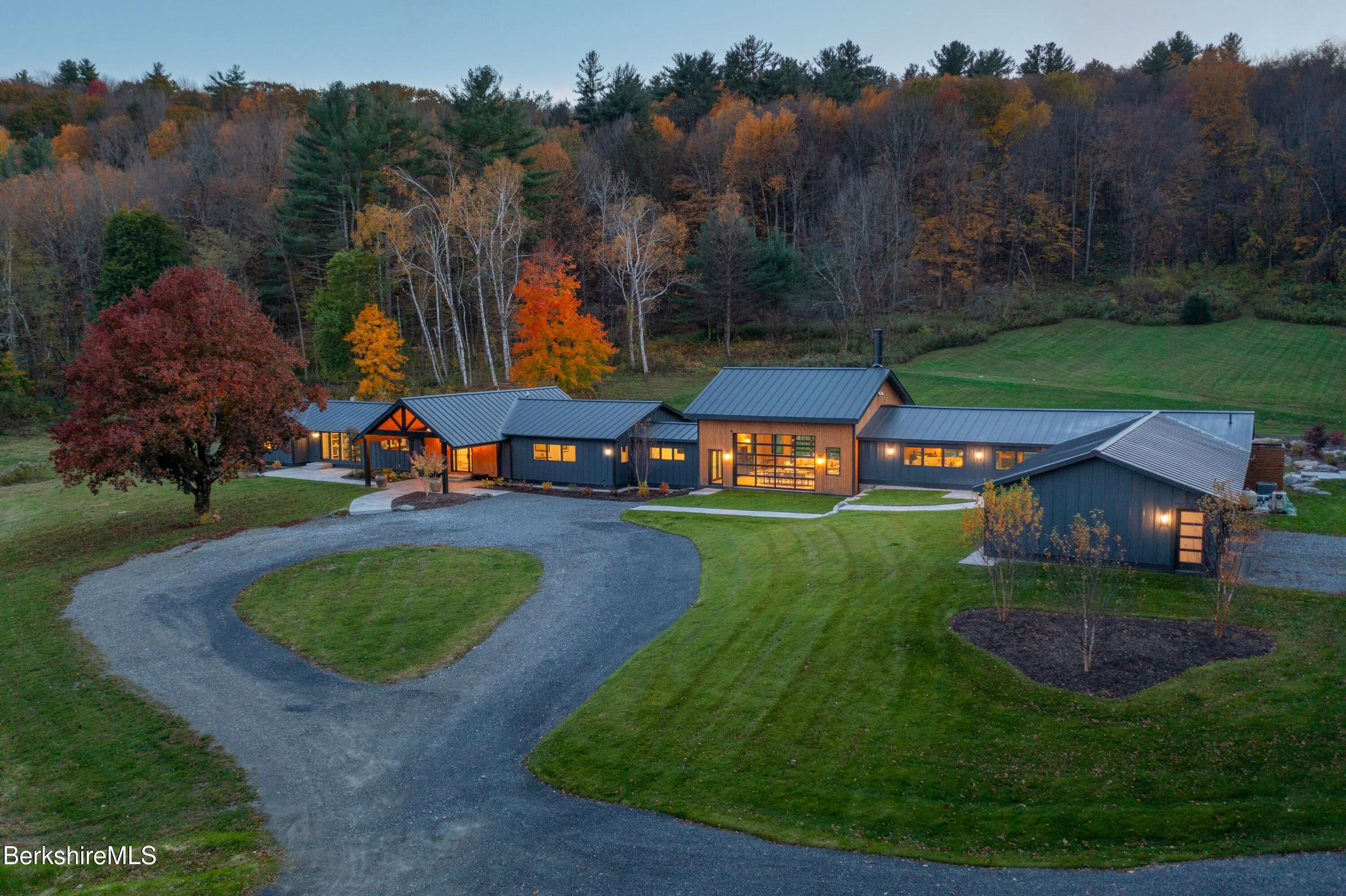 an aerial view of a house with outdoor space swimming pool and mountains