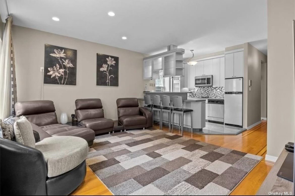 a living room with furniture and kitchen view