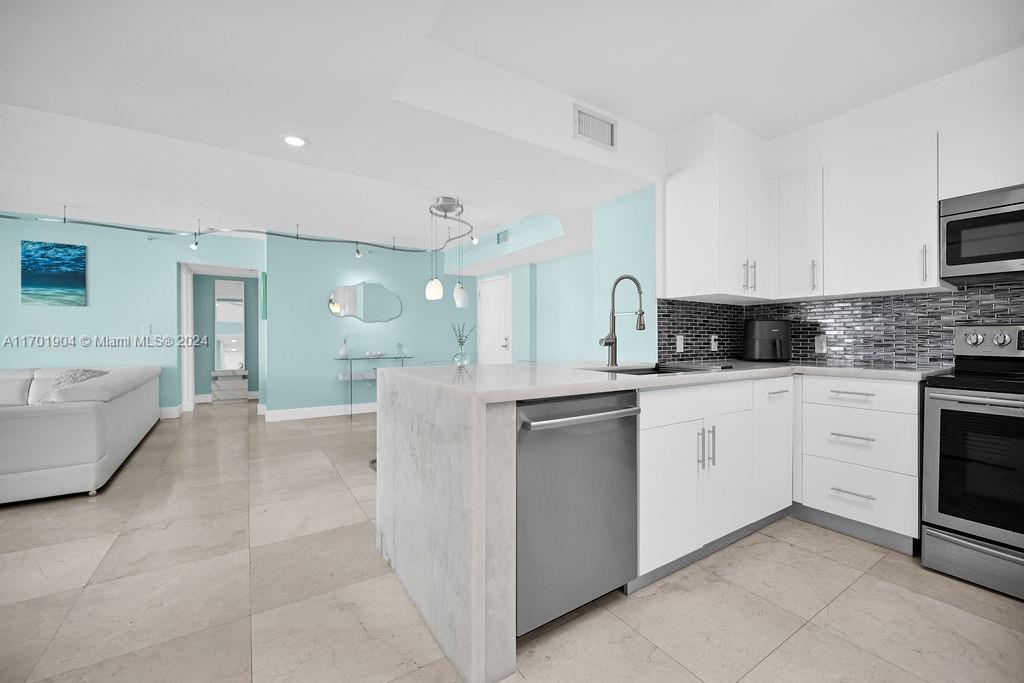 a kitchen with cabinets and white appliances