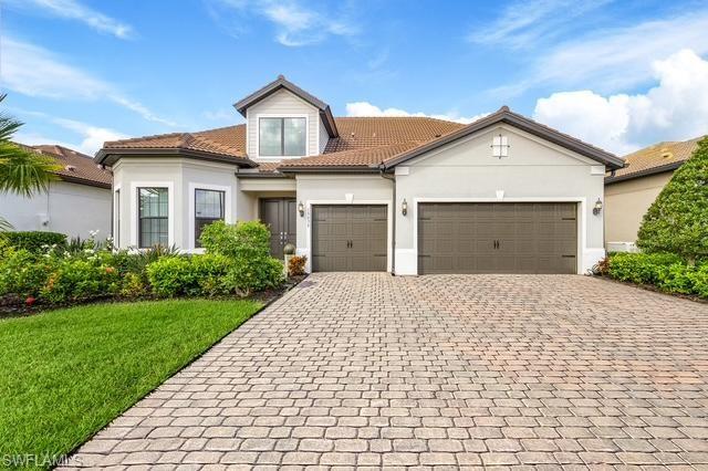 View of front of property with a garage and a front yard