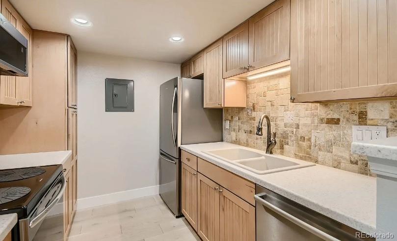 a kitchen with a sink appliances and cabinets