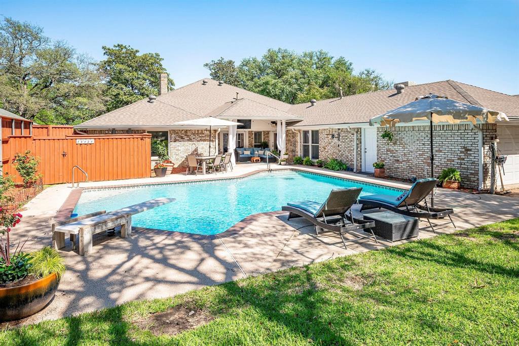 a view of a house with backyard sitting area and garden