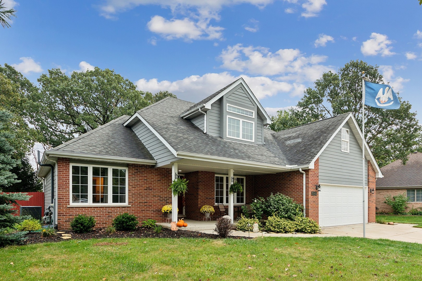 a view of a house with a yard and plants