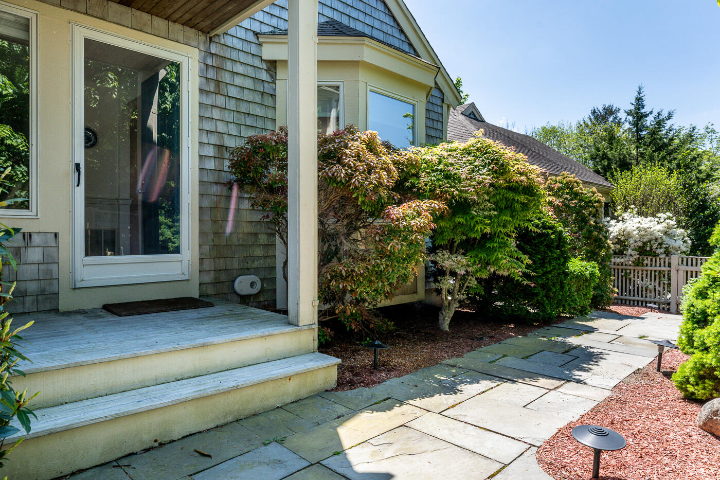 a view of a house with backyard and sitting area