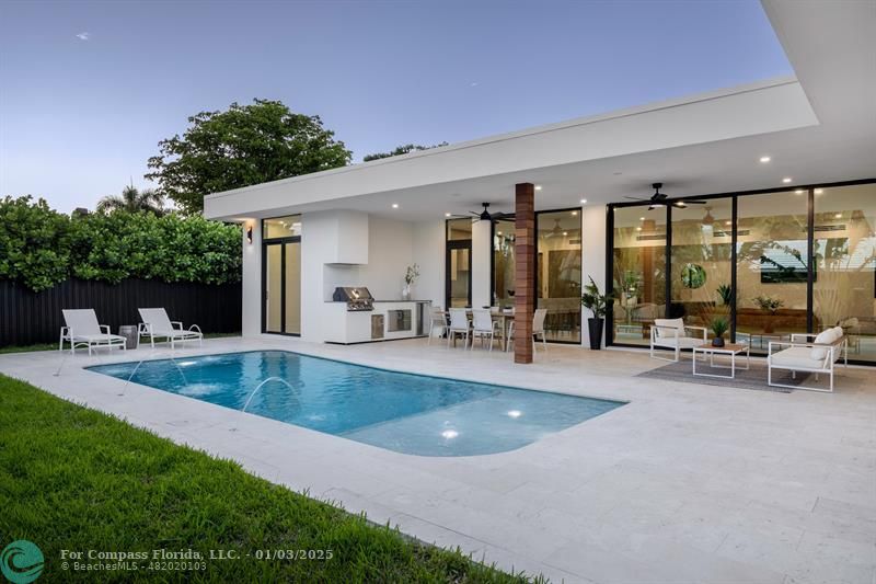 a view of a swimming pool with outdoor seating