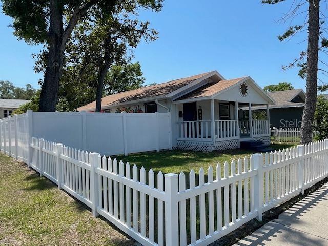 a view of a house with wooden fence