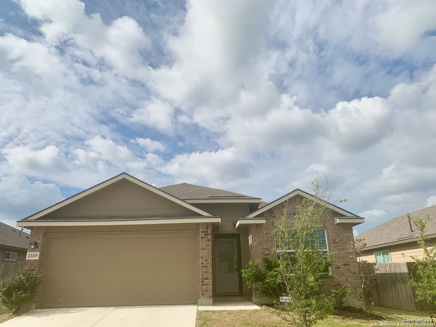 a front view of a house with a yard