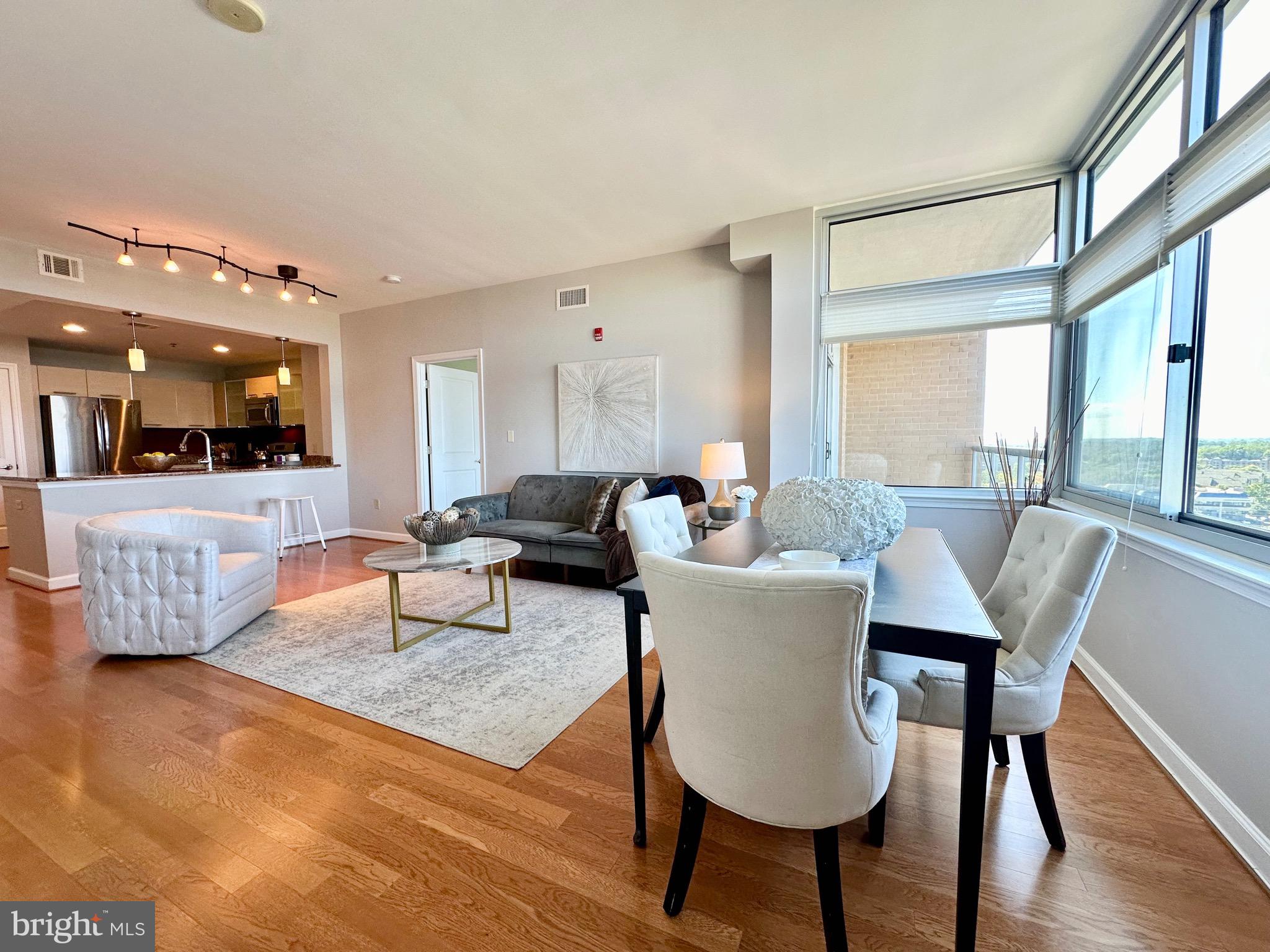 a living room with furniture wooden floor and a table