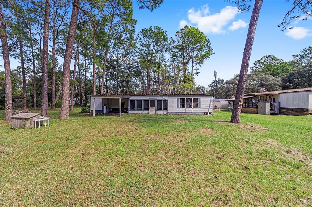 a view of a house with a backyard porch and sitting area