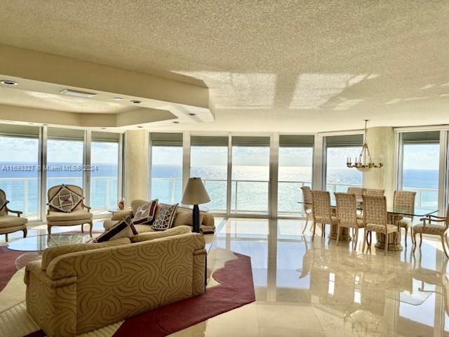 a living room with furniture and floor to ceiling windows