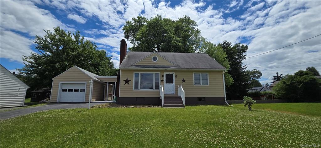 Cape Cod-style home with a garage and a front yard