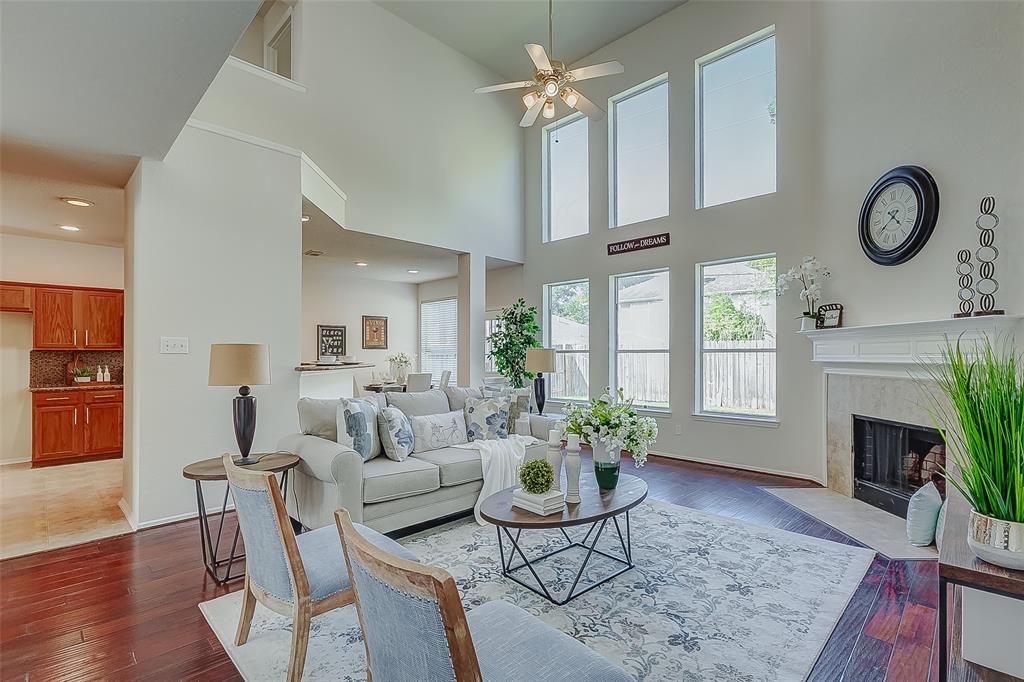 Wow! Double row of windows and high ceilings makes this living area a great place to gather and create memories with your loved ones.