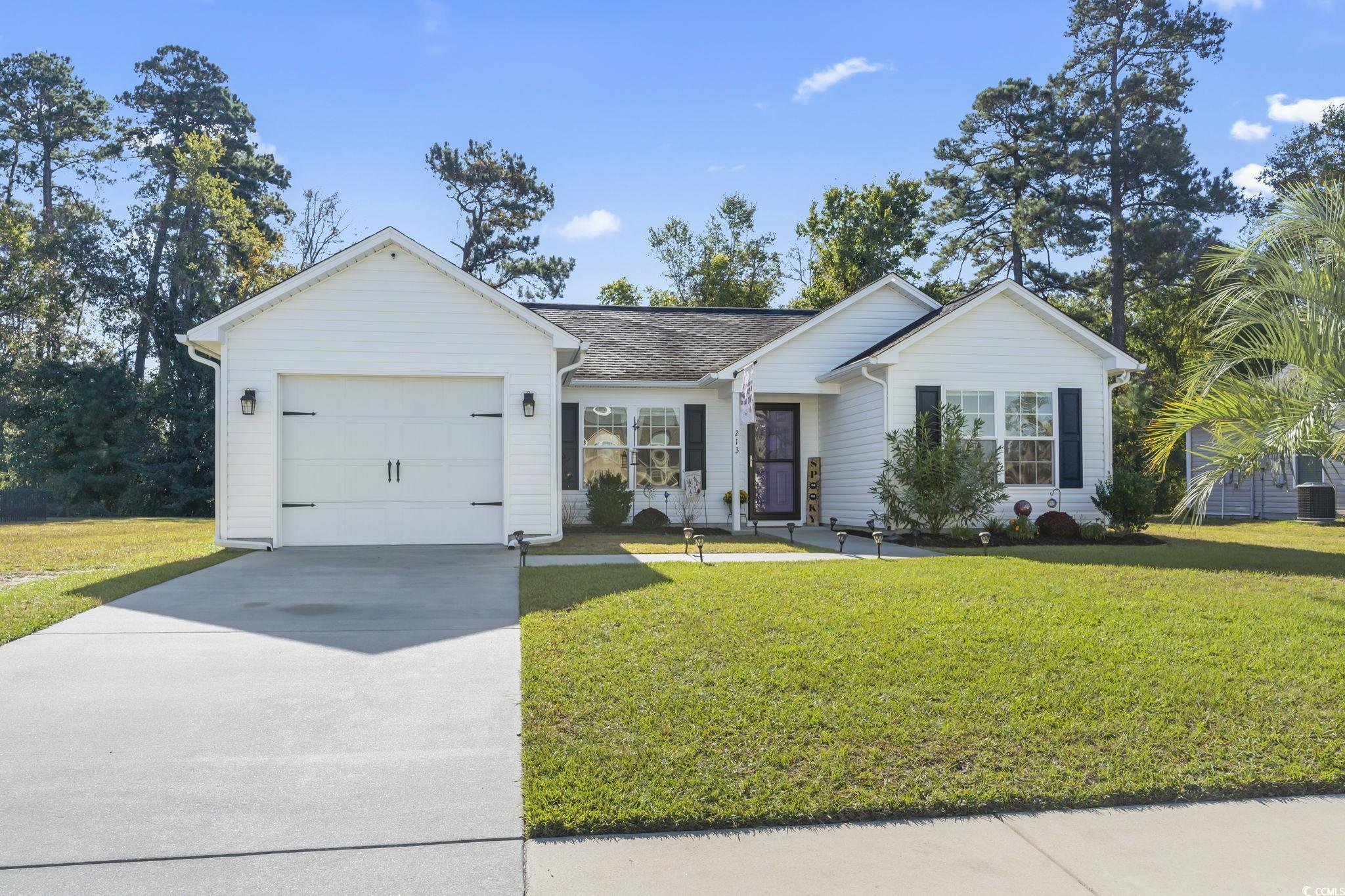 Single story home with a front lawn and a garage