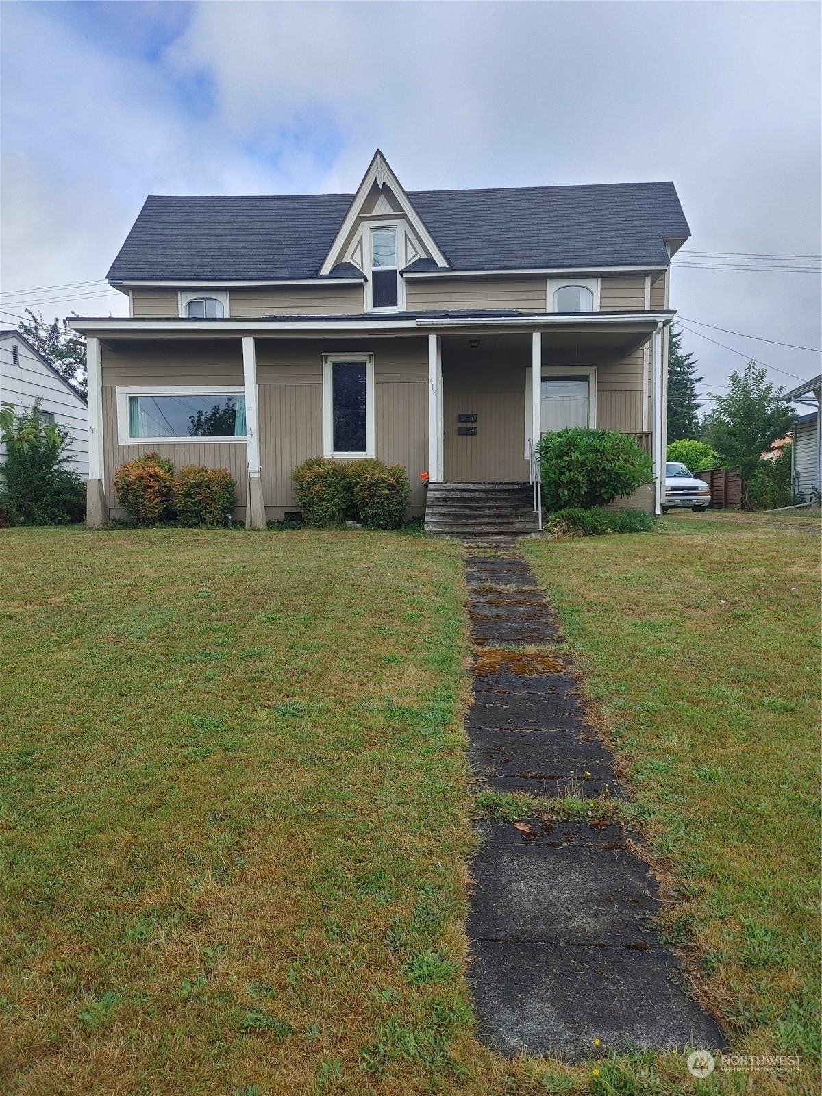 a front view of a house with a garden