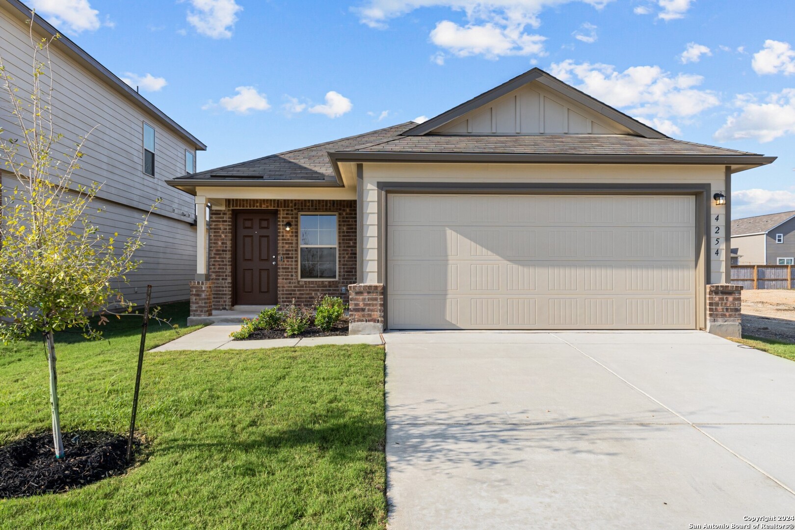 a front view of a house with a yard