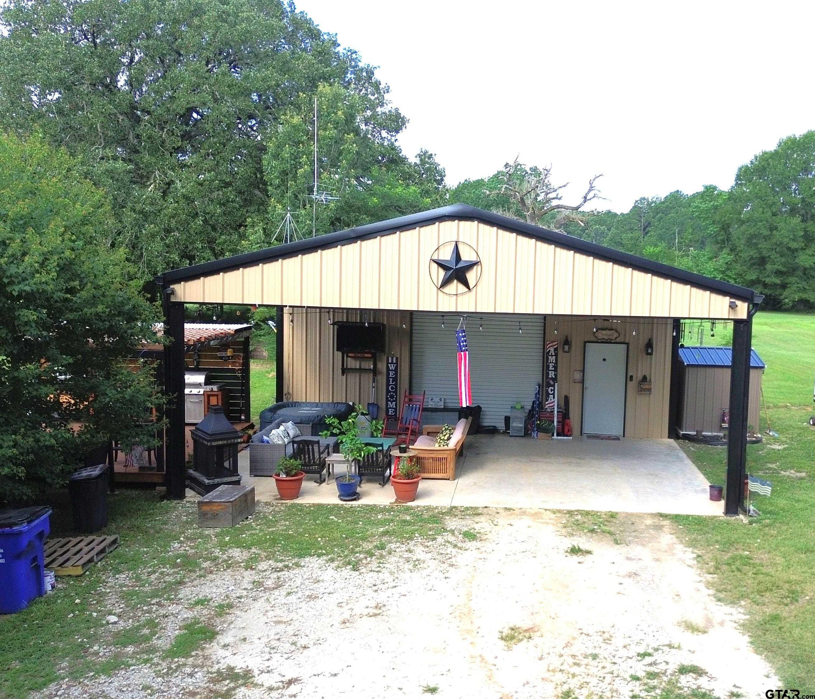 a view of a house with backyard and sitting area