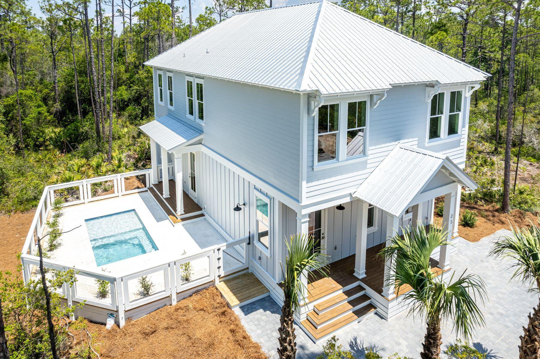 a aerial view of a house with a yard and balcony