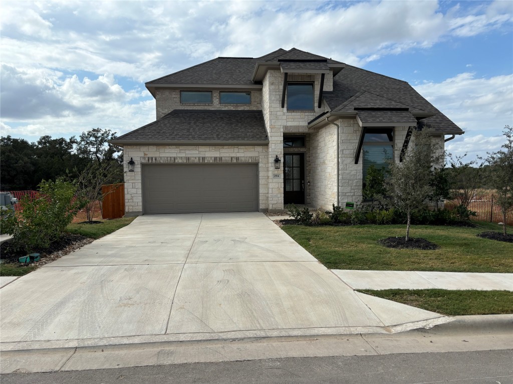 a front view of a house with yard