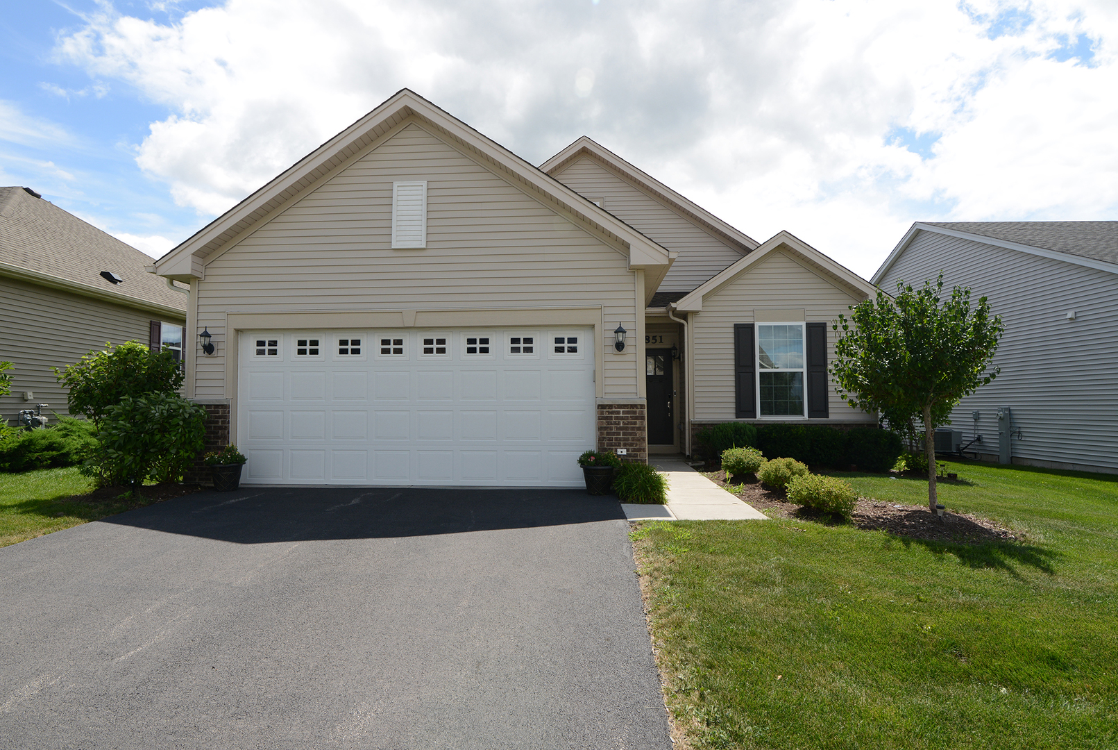 a front view of a house with a yard and garage