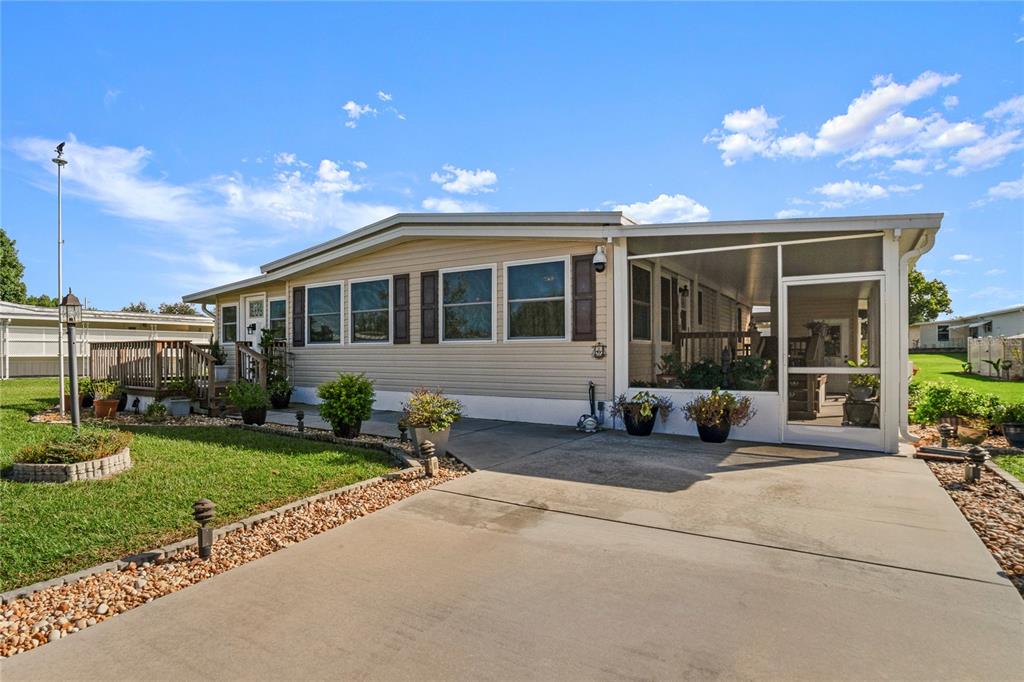 a front view of a house with a garden and patio