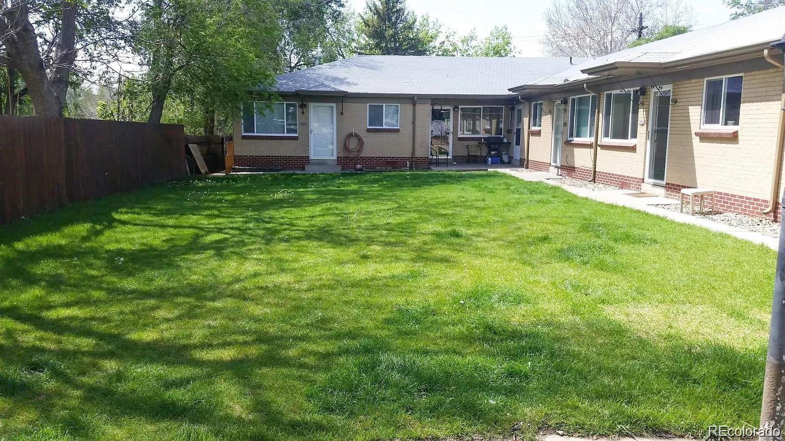 a view of a house with a yard and sitting area