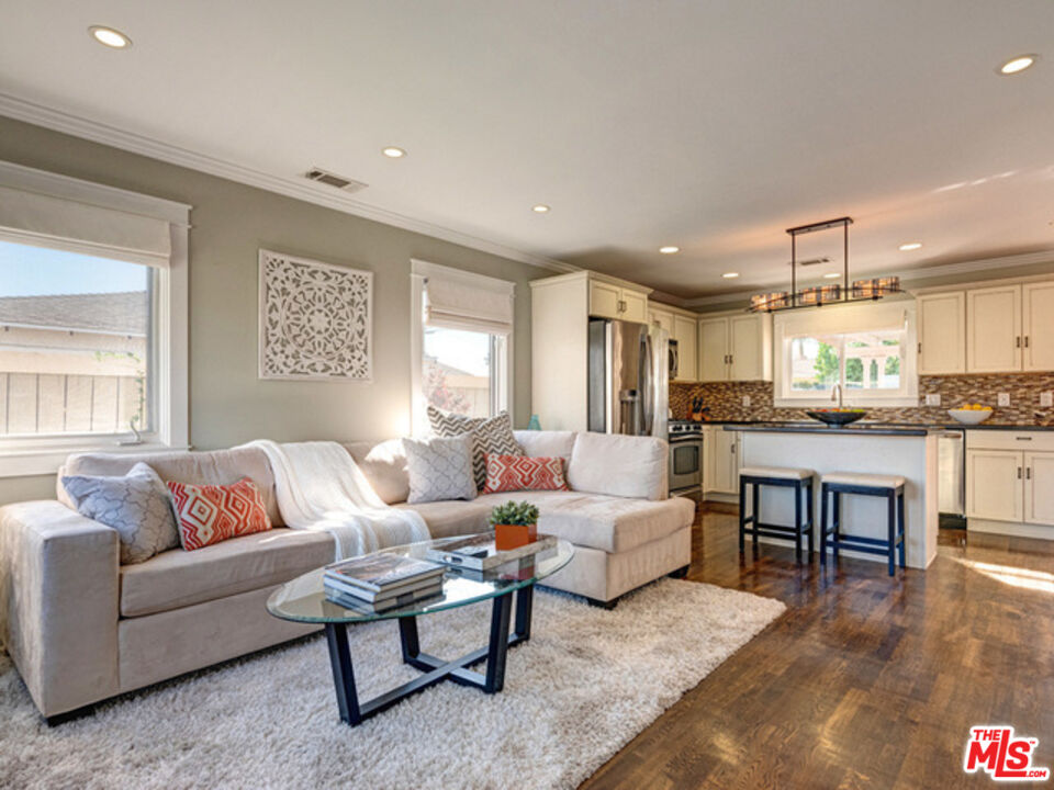 a living room with furniture and kitchen view