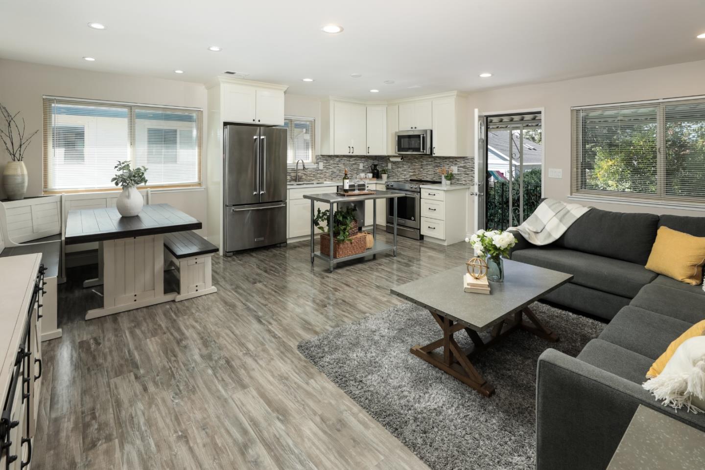 a kitchen with a table chairs refrigerator and cabinets